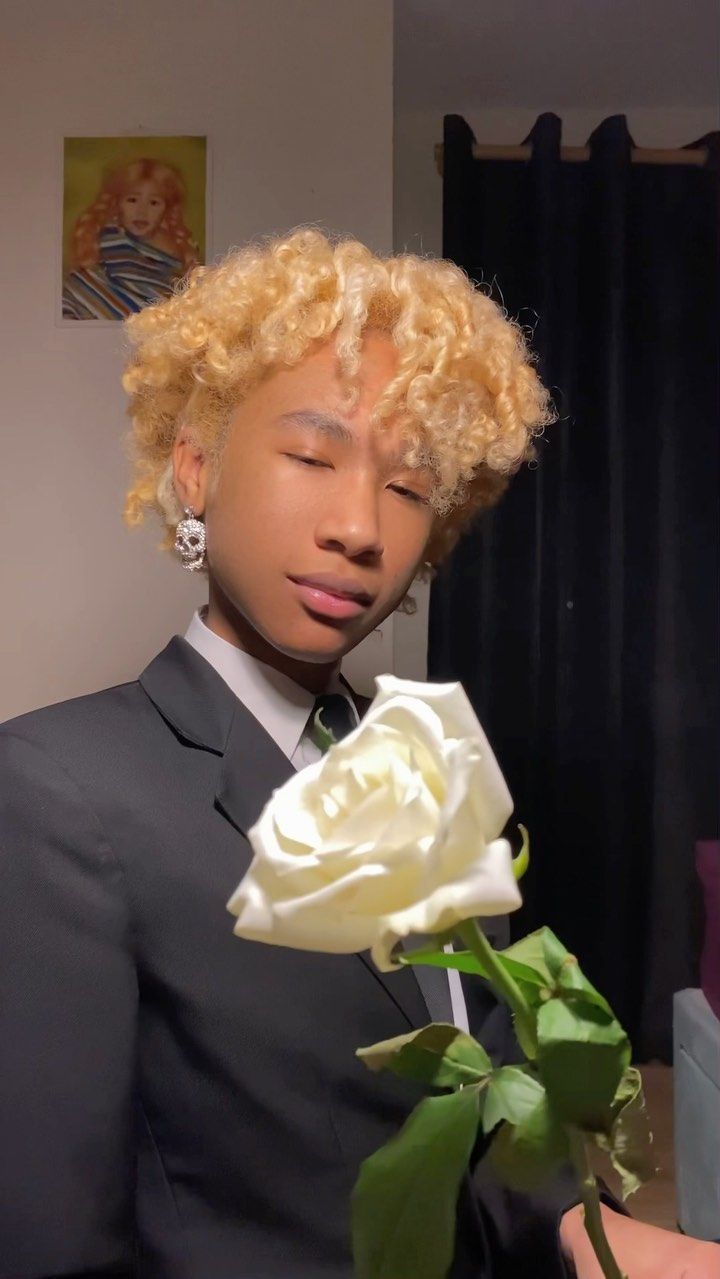 Albert posing with a white rose.